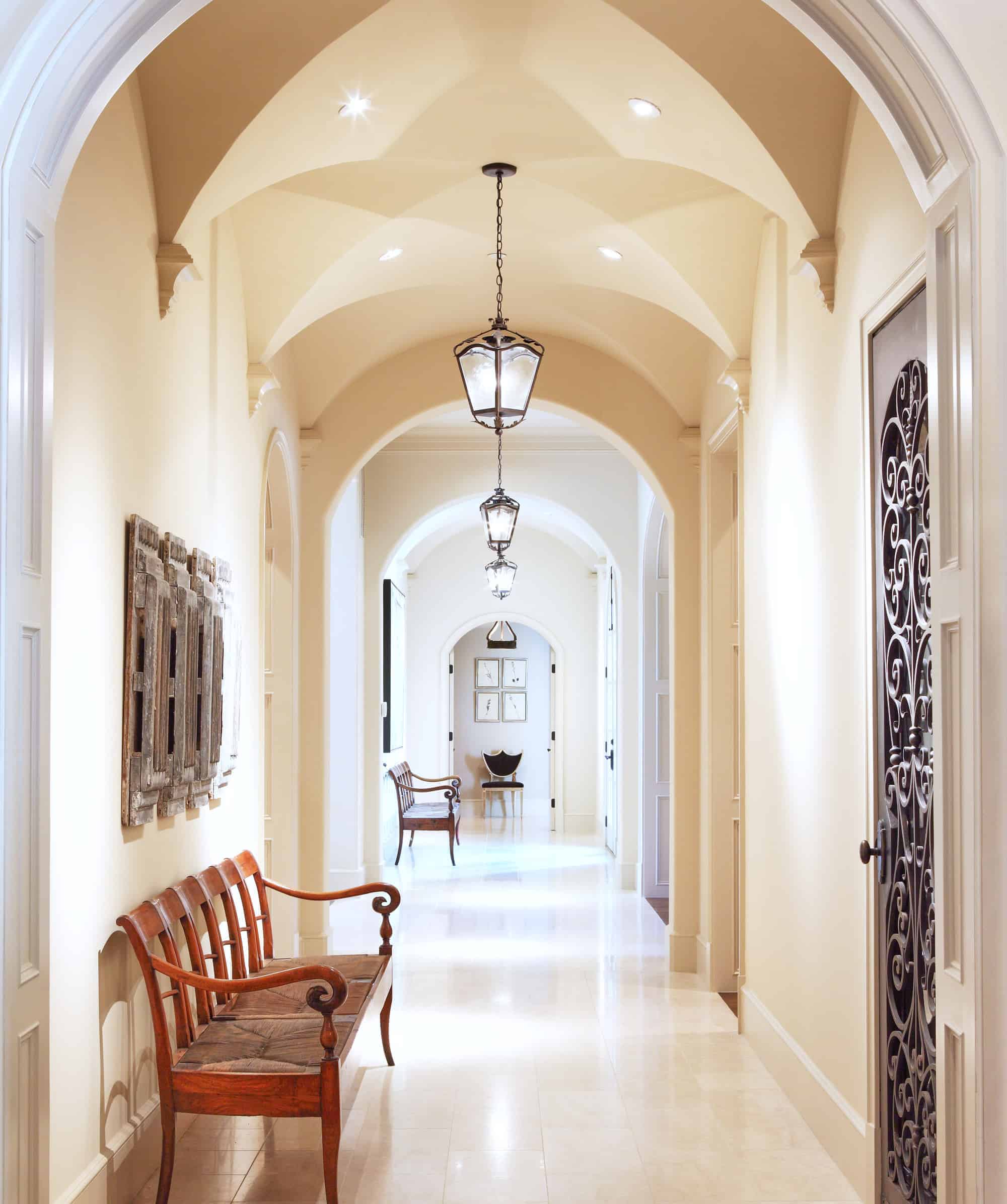 A long hallway with tall ceilings and decorations
